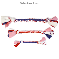 Handmade braided fleece dog tug toy in Valentine paw colors